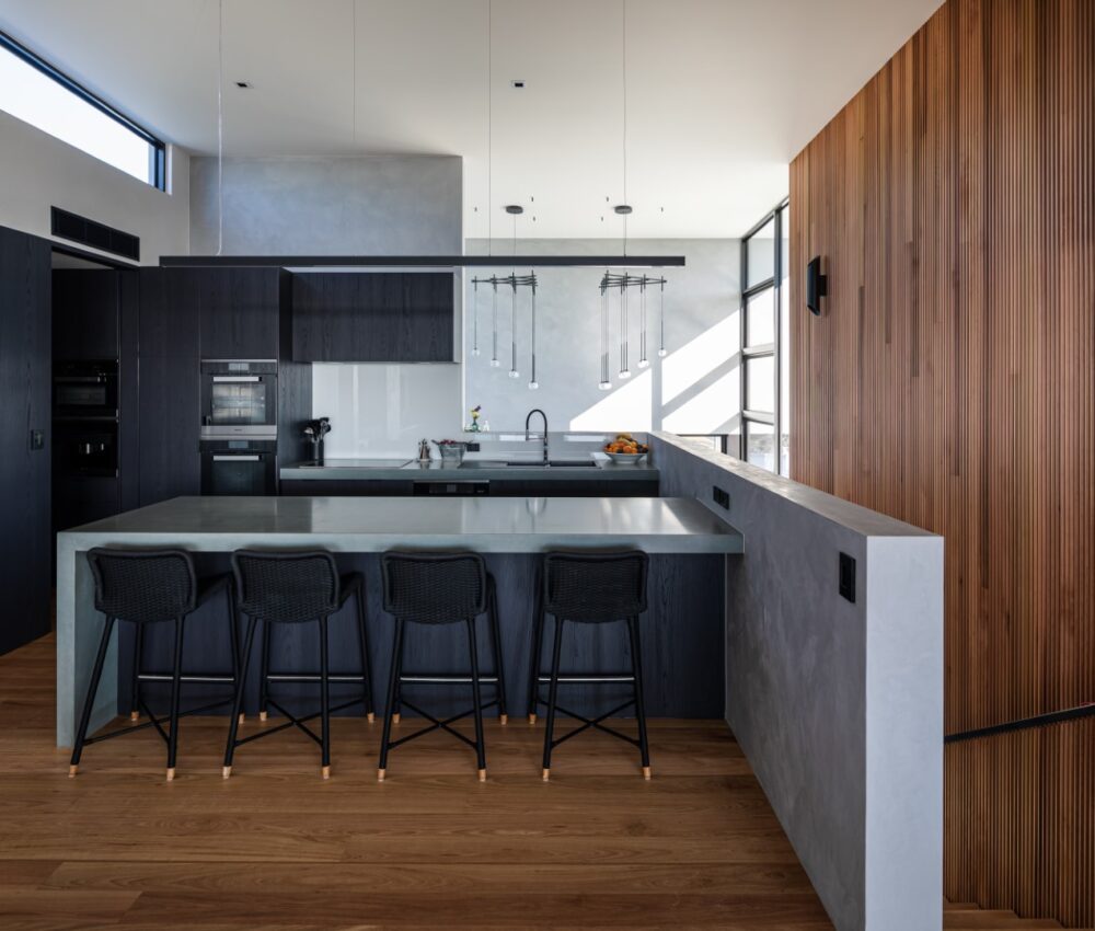 Dedicated home office in a coastal Northern NSW home featuring north-facing glazing, timber desk joinery, and acoustic wall panels