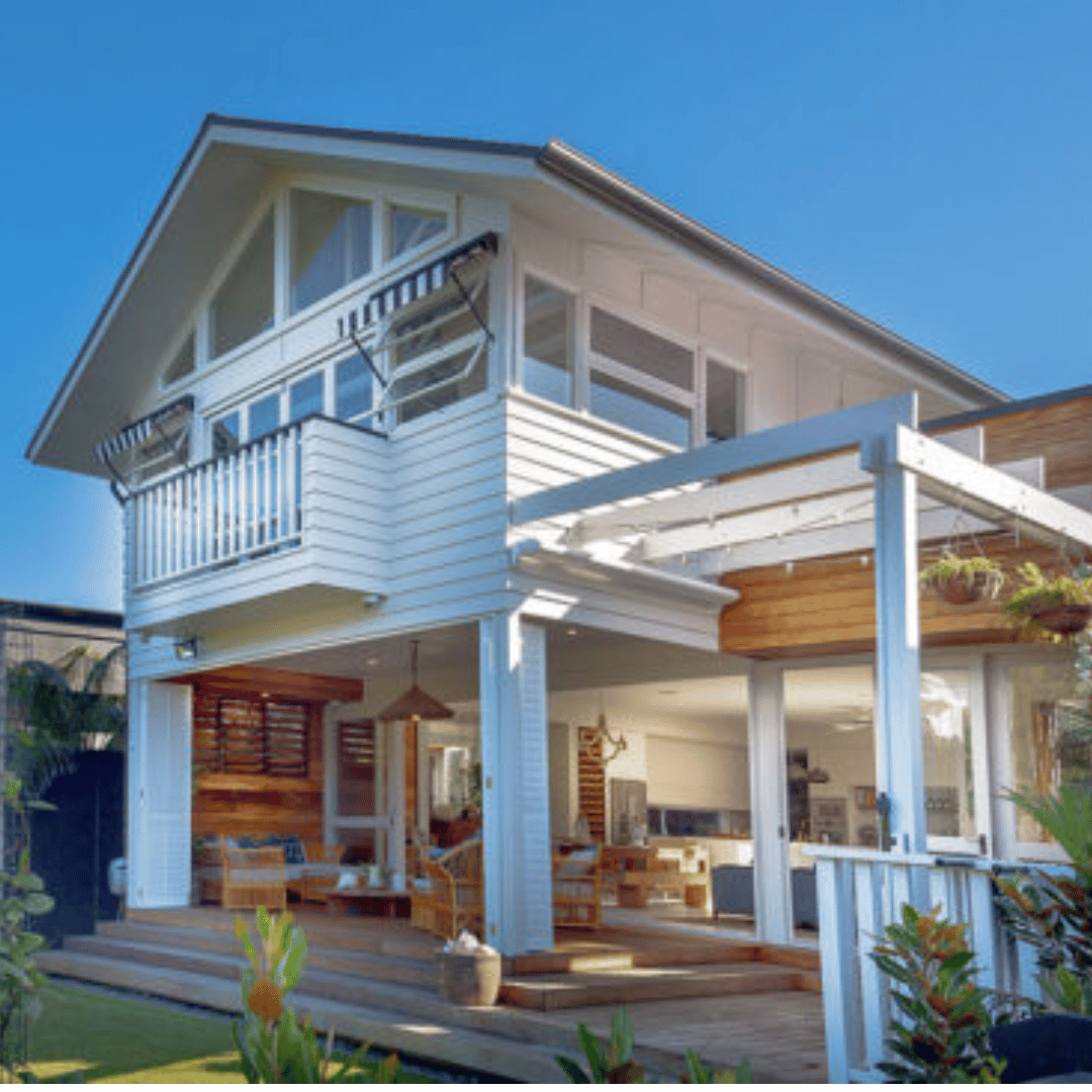 Modern two-story beach house in Lennox Head NSW with black weatherboard cladding and a skillion roof by CREATE Architecture.