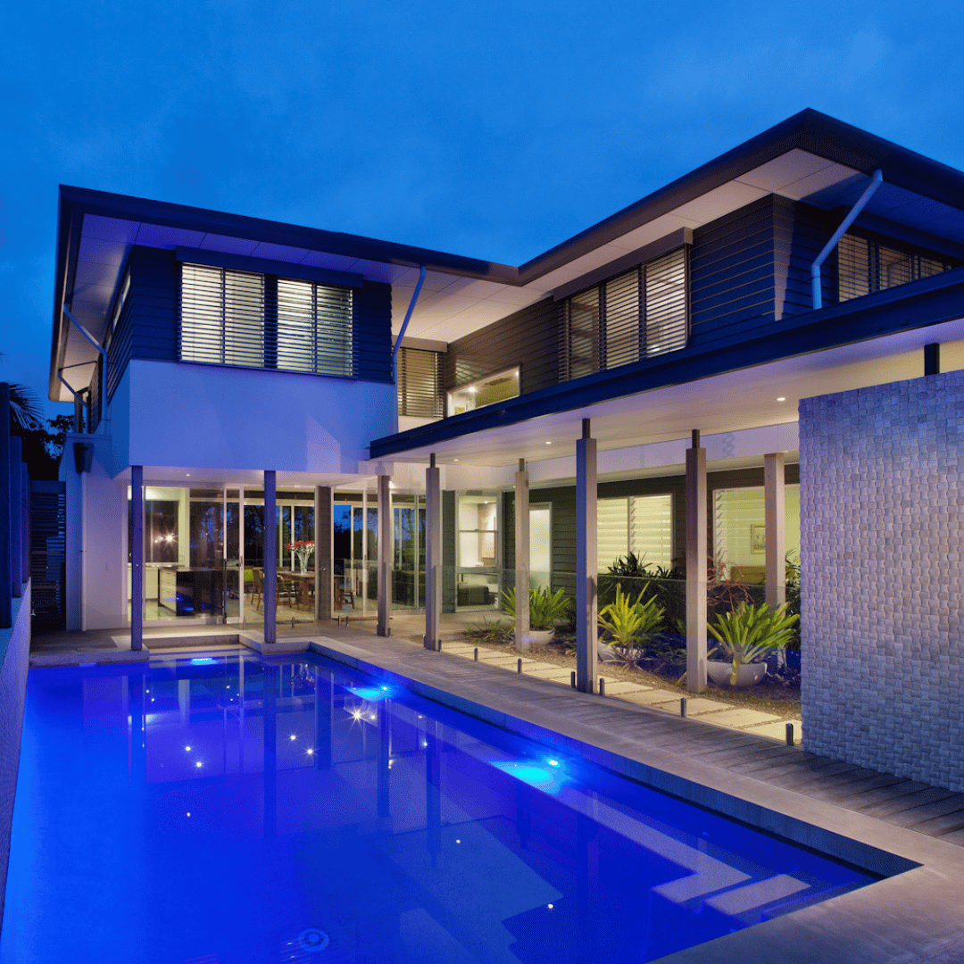 Modern coastal home in Elanora, Northern NSW, featuring a mix of white brick, black cladding, and timber, with a native landscape by CREATE Architecture.