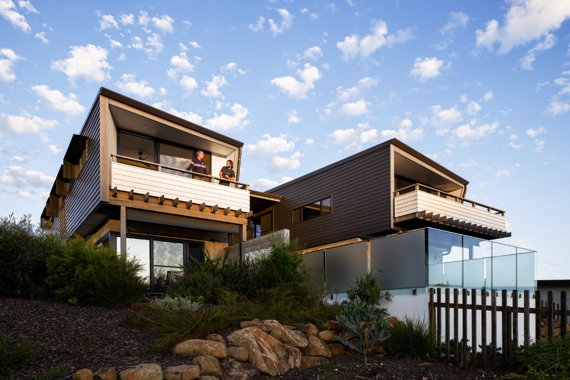 Sustainable townhouse development in Casuarina, NSW, by Create Architecture, featuring private balconies, native landscaping, and coastal-inspired architecture.